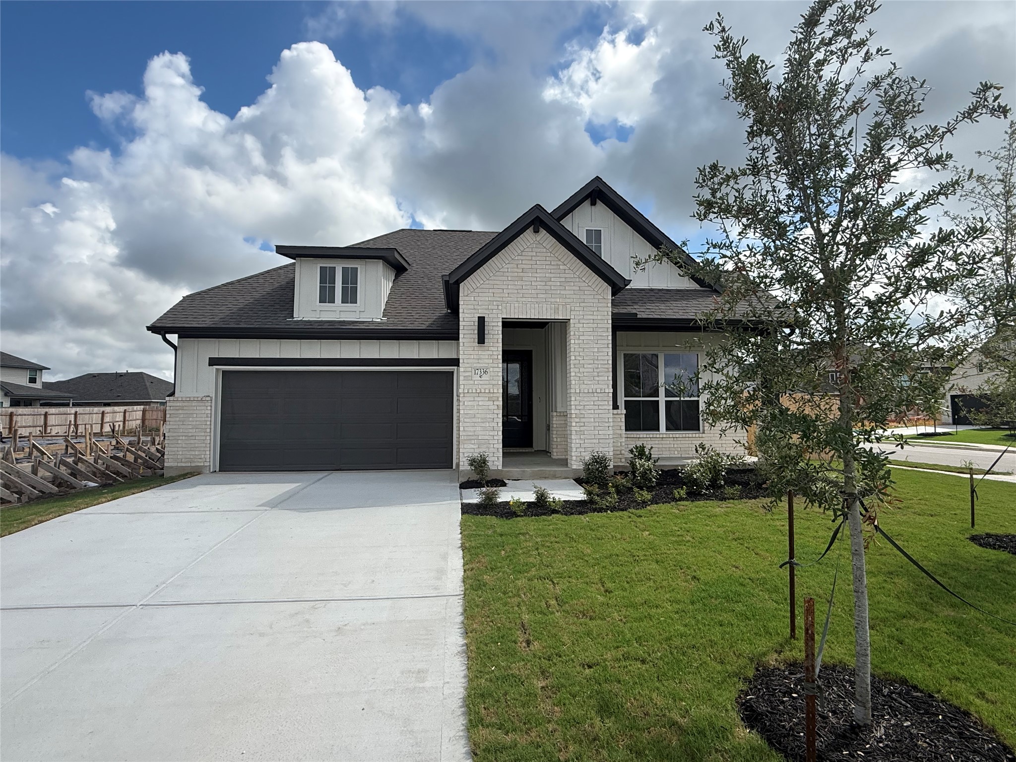a front view of house with yard and green space