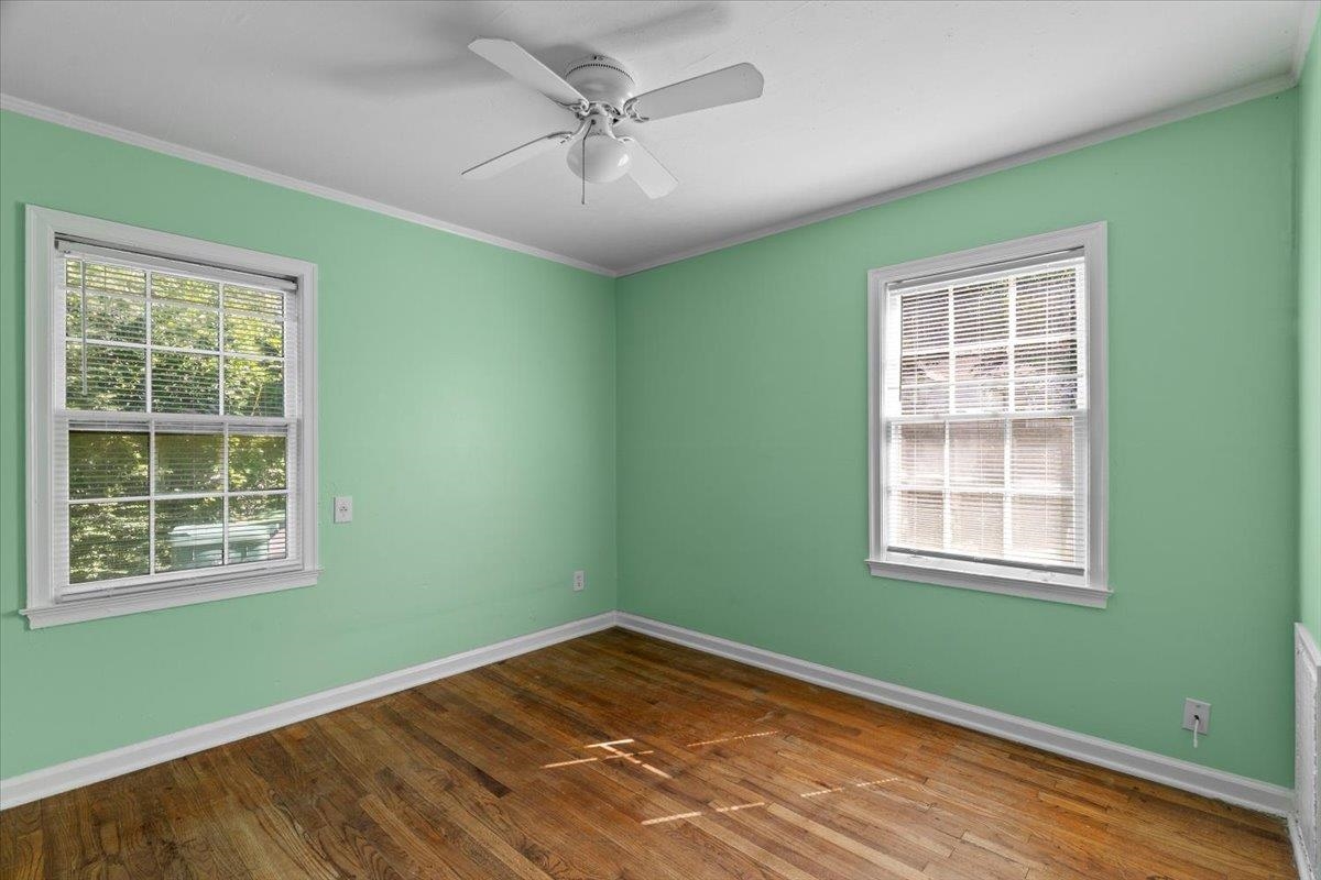 3801 Wilshire Road Memphis, TN 38111 - Photo 3 of 19 Spare room featuring wood finished floors, healthy amount of natural light, ornamental molding, and a ceiling fan