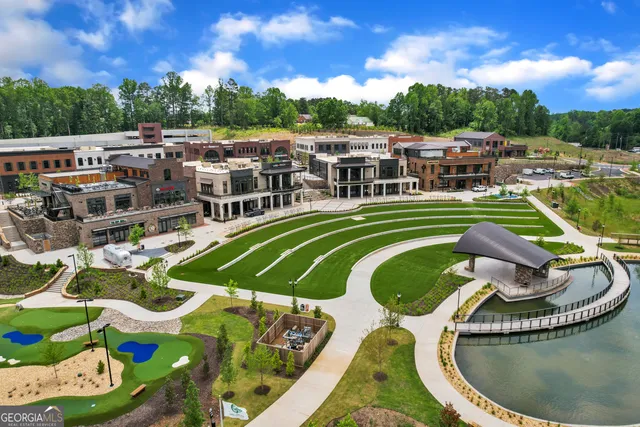 a view of a swimming pool with a patio and a yard