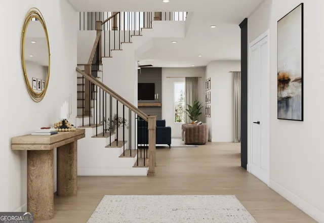 a view of a hallway with wooden floor and entryway