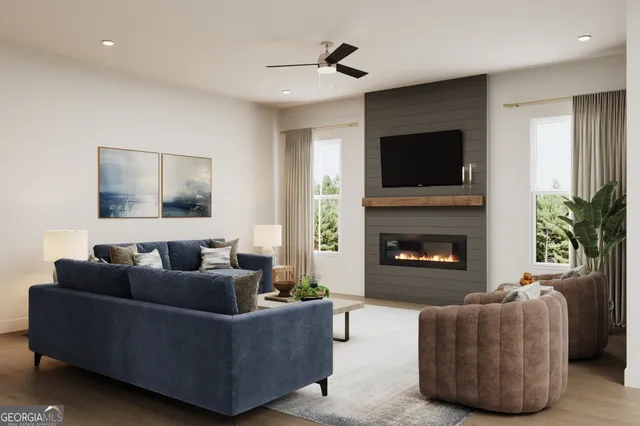 a living room with furniture a flat screen tv and a fireplace