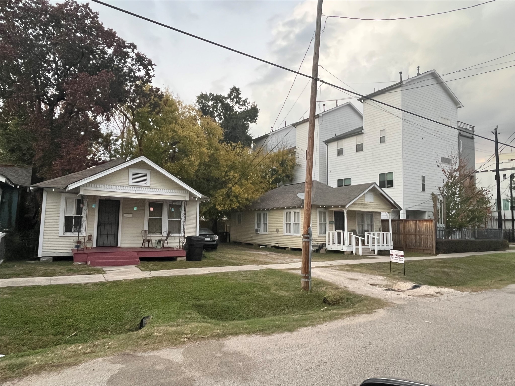 a front view of a house with a yard and trees