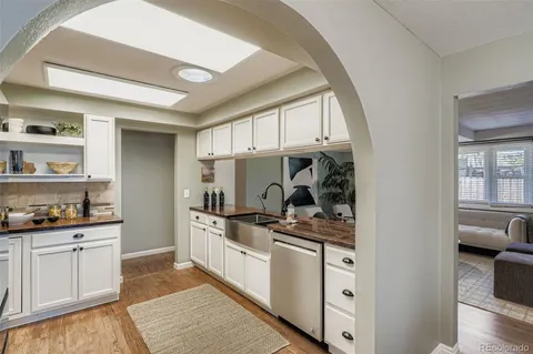 a kitchen with stainless steel appliances a stove a sink and cabinets