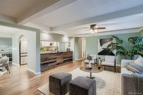 a living room with furniture and view of kitchen