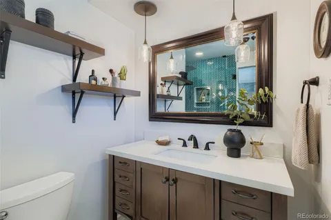 a bathroom with a sink vanity granite and a mirror