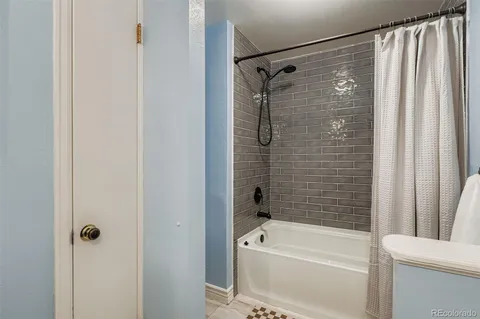 a bathroom with a shower a bathtub and a shower