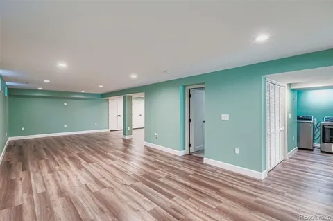 a view of a room with wooden floor and window
