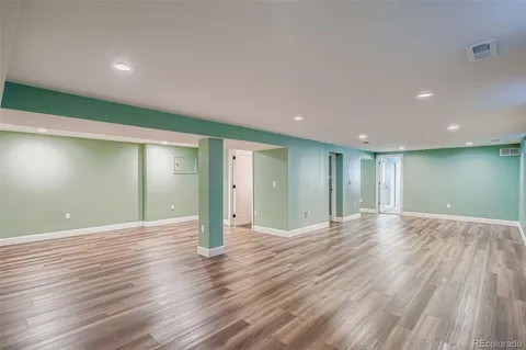 a view of an empty room with wooden floor