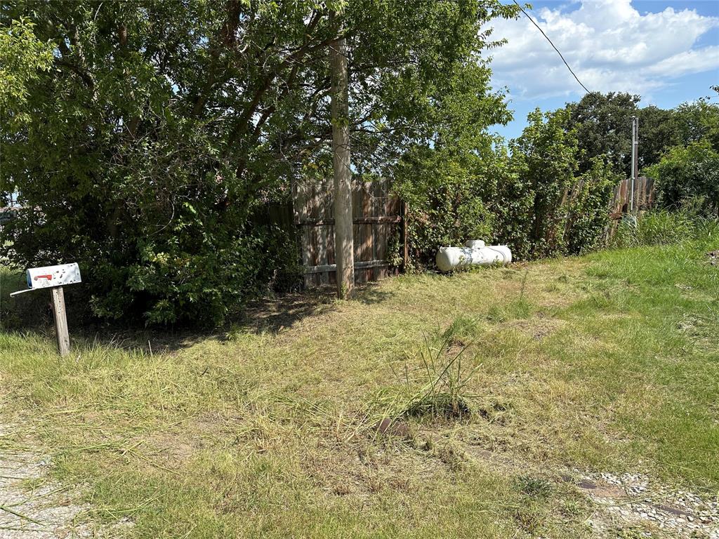 219 Hubbard Road Sunset, TX 76270 - Photo 2 of 18 a backyard of a house with lots of green space
