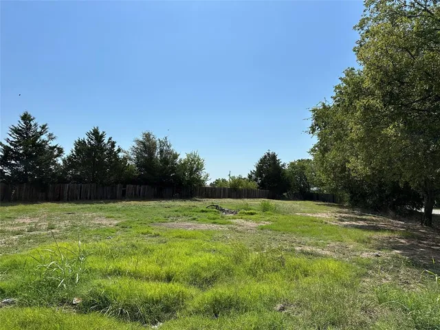 a view of outdoor space with a garden and trees