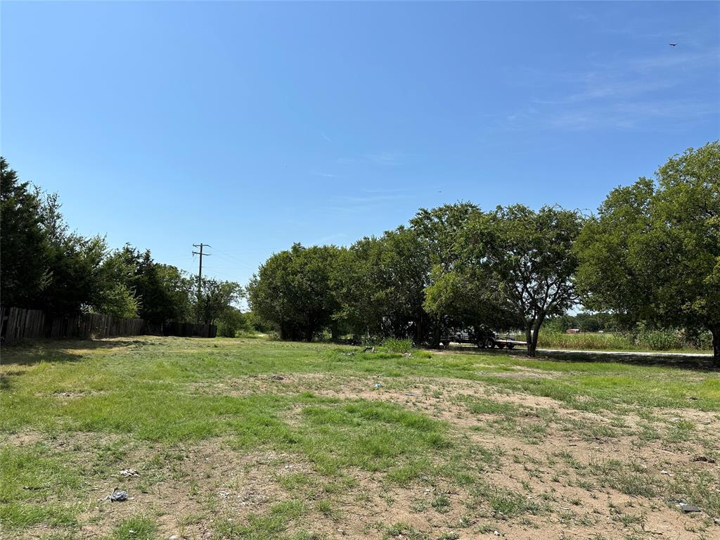 219 Hubbard Road Sunset, TX 76270 - Photo 7 of 18 a view of a grassy field with trees in the background