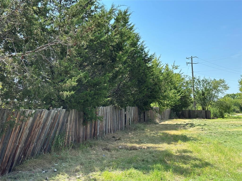 219 Hubbard Road Sunset, TX 76270 - Photo 10 of 18 a view of a yard with a tree