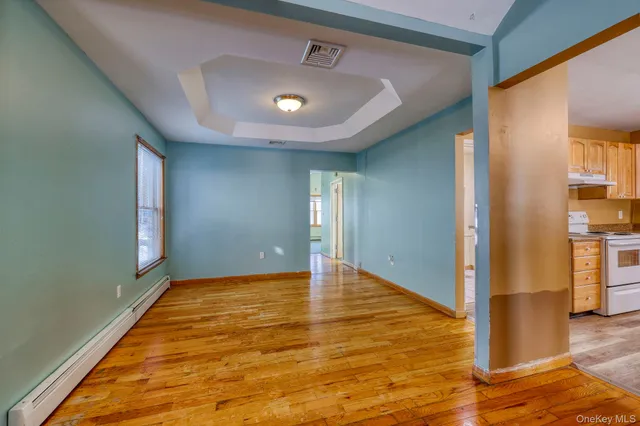 a view of a living room with hardwood floor
