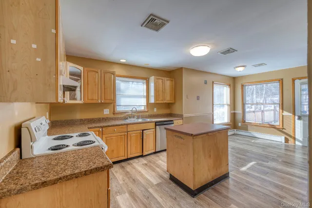 a room with pool table and wooden floor