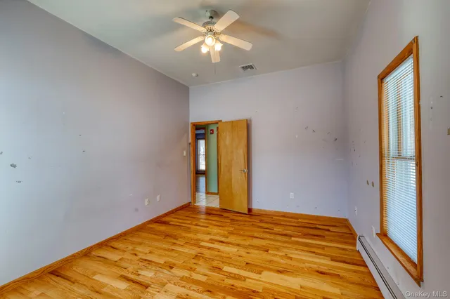 a wooden bench sitting in the middle of a yard