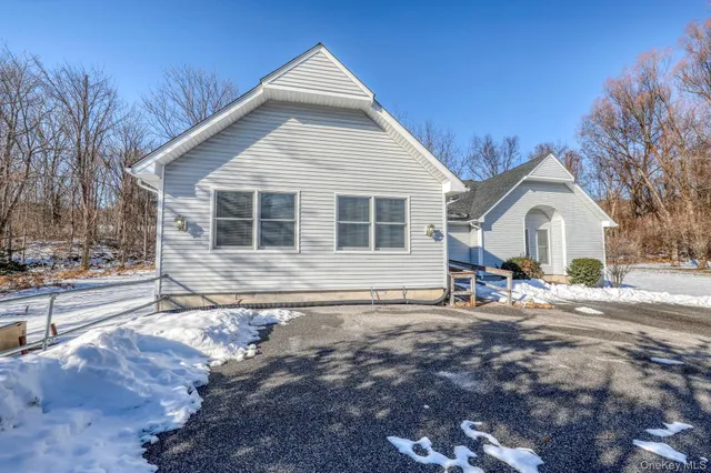 a view of a house with backyard and deck