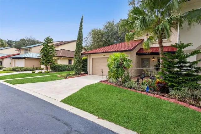 a house with green field in front of it