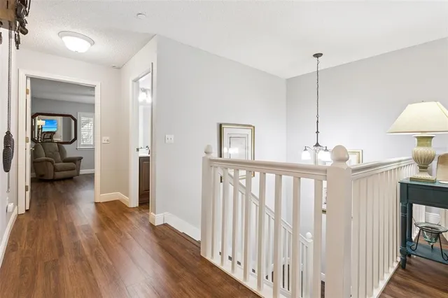 a view of hallway with wooden floor