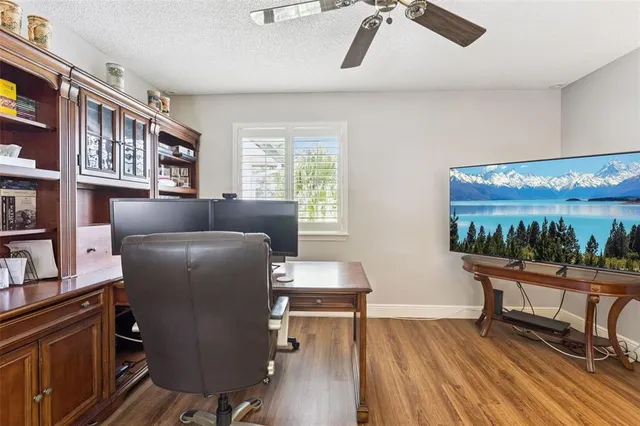 a work room with furniture and a floor to ceiling window