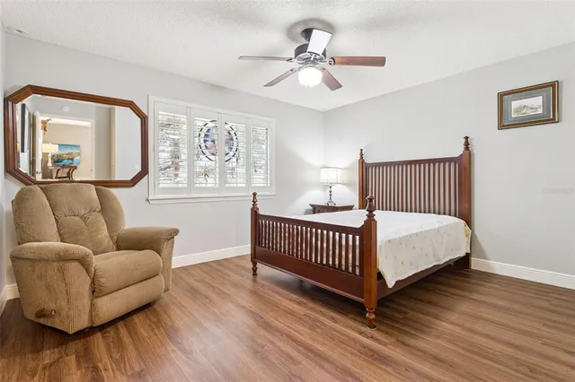 a bedroom with furniture and wooden floor
