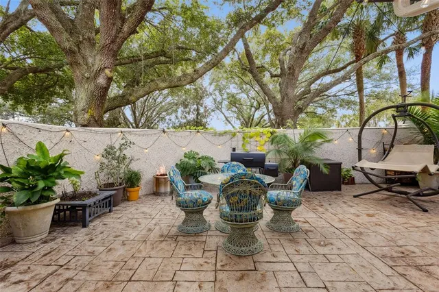 a view of a backyard with sitting area and garden