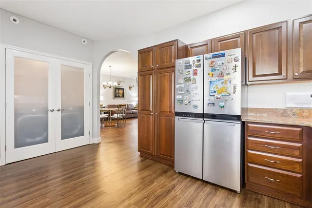 a kitchen with stainless steel appliances granite countertop a refrigerator and a stove top oven