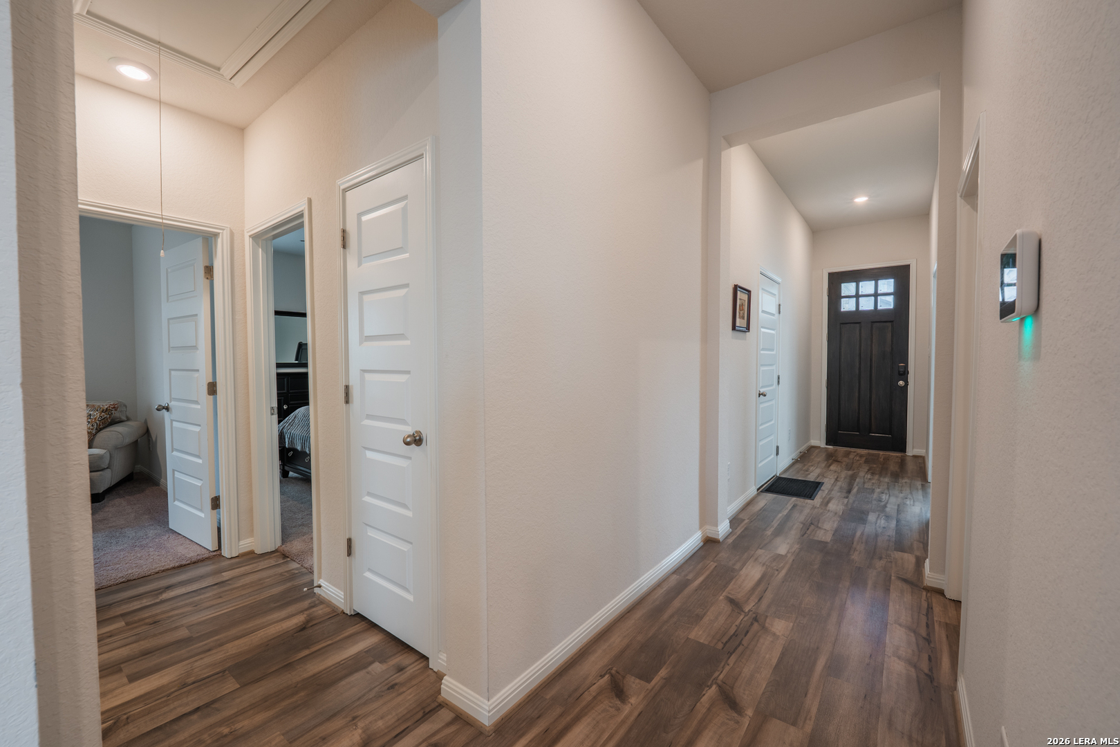 4947 Ranahan Pass St. Hedwig, TX 78152 - Photo 23 of 37 a view of a hallway with wooden floor and a bathroom