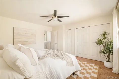 a bedroom with a bed and a potted plant