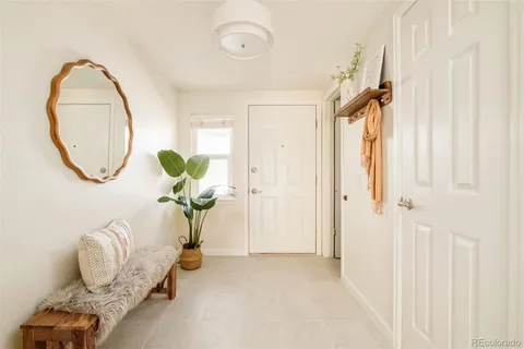 a view of a livingroom with furniture and a window