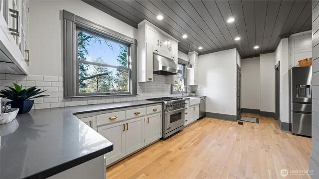 a kitchen with stainless steel appliances a refrigerator sink and stove