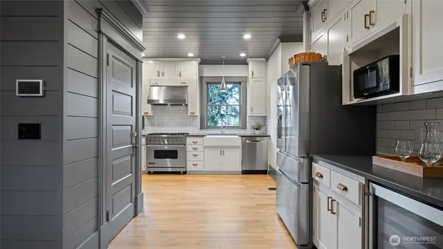 a kitchen with stainless steel appliances a stove sink and refrigerator