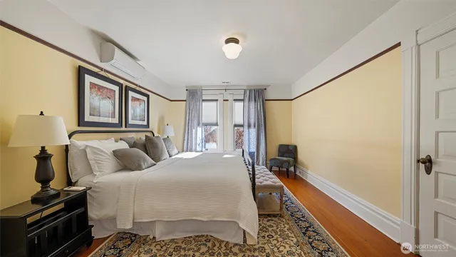 a bedroom with a bed dresser and a window