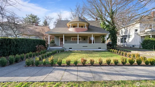 a front view of a house with a yard outdoor space and swimming pool