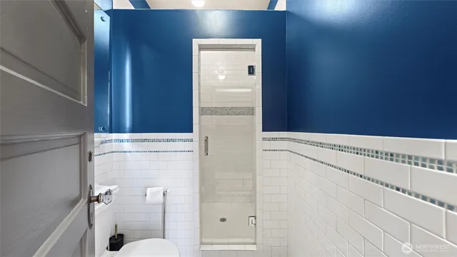a bathroom with a tub sink and mirror