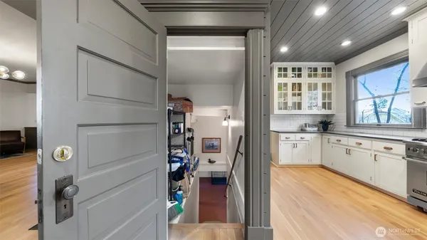 a view of a room with door and wooden floor