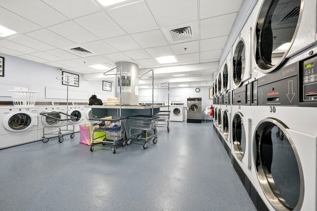 a view of a storage and utility room with washer and dryer