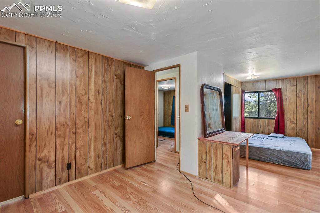 410 Rangeview Road Divide, CO 80814 - Photo 11 of 23 a bedroom with furniture and large windows