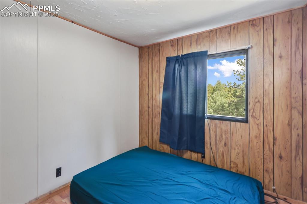 410 Rangeview Road Divide, CO 80814 - Photo 12 of 23 a view of an empty room with wooden floor and a window