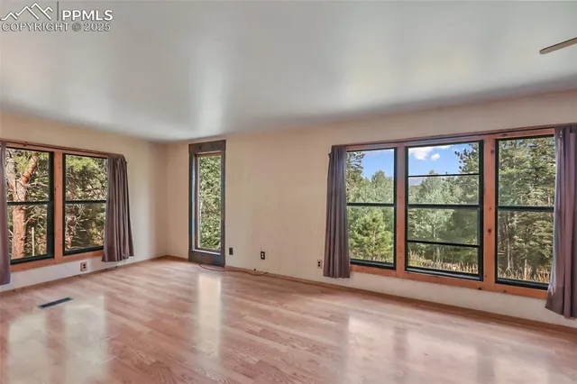 a view of an empty room with large windows