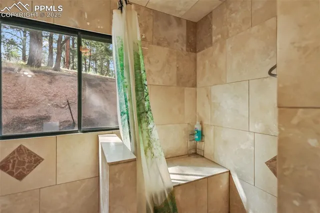 a bathroom with a bathtub and a shower