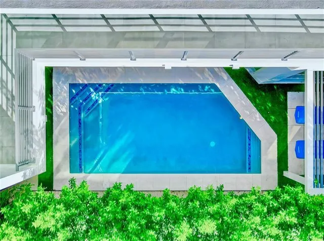a room with pool table and windows