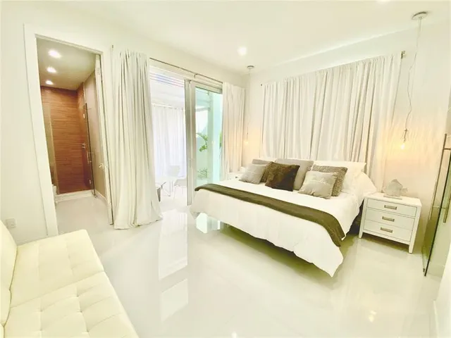 a bedroom with a large bed and a couch