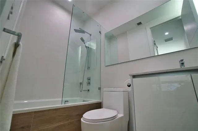 a bathroom with a sink a mirror and a toilet