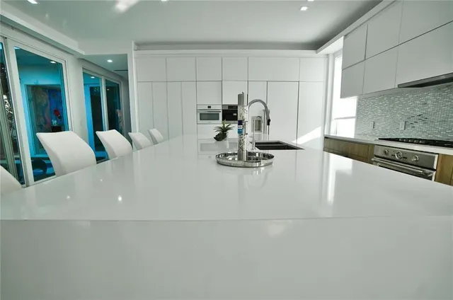 a view of kitchen with furniture and refrigerator
