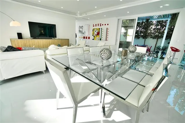 a living room with furniture and floor to ceiling window