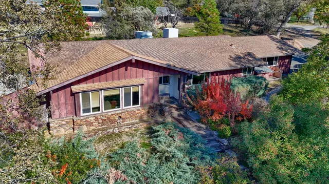 a aerial view of a house with a yard and sitting area