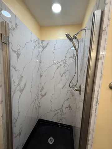 a bathroom with a shower and a sink