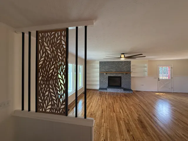 wooden floor in an empty room with a fireplace