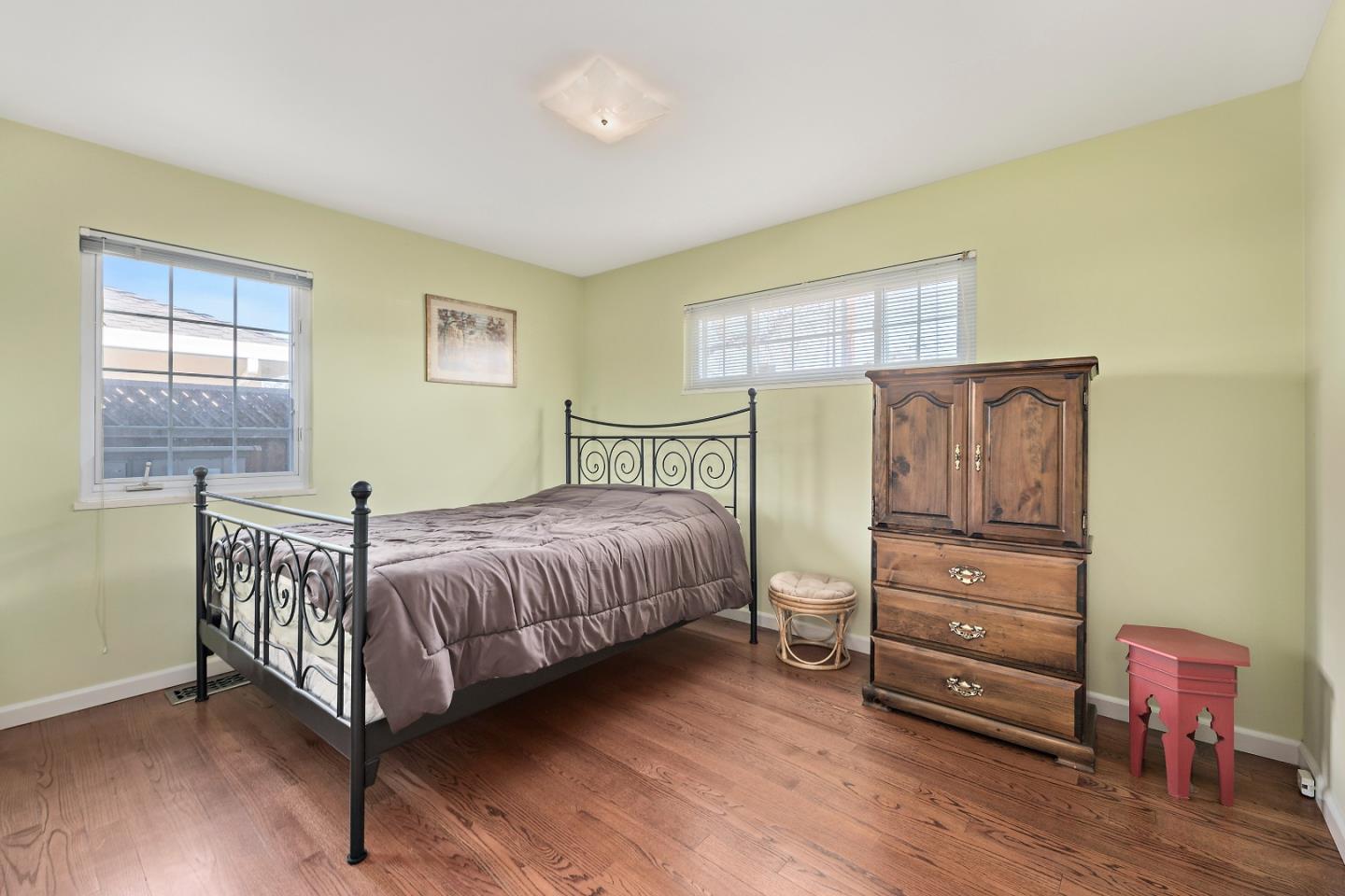 1019 Mango Avenue Sunnyvale, CA 94087 - Photo 11 of 17 a bedroom with a bed and wooden floor