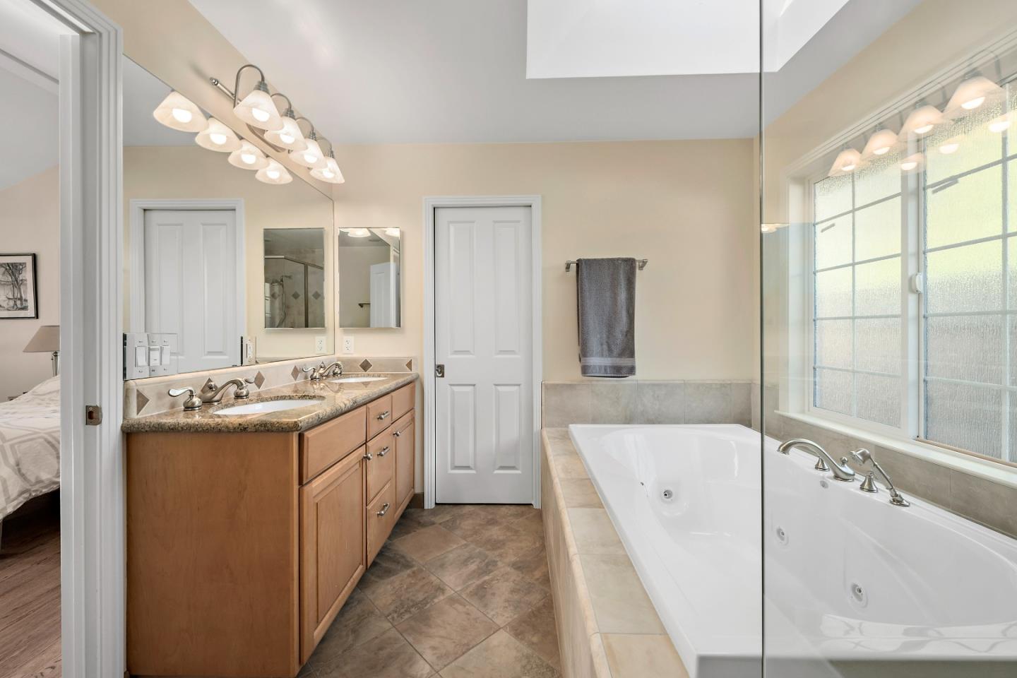 1019 Mango Avenue Sunnyvale, CA 94087 - Photo 14 of 17 a bathroom with a tub sink and mirror